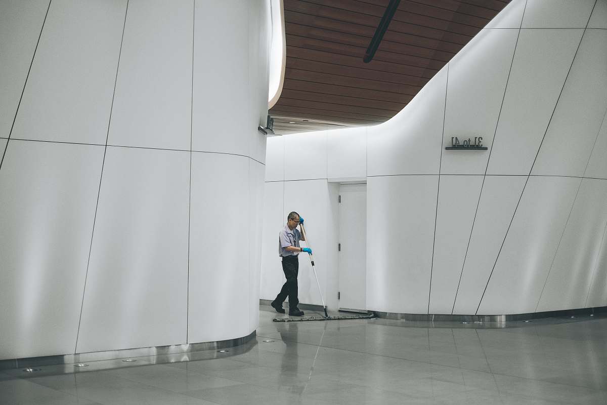 cleaning man cleaning on floor beside white wall modern