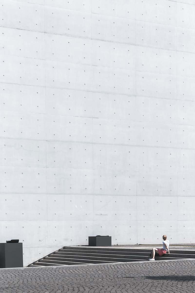germany man sitting on gray concrete stairs during daytime berlin