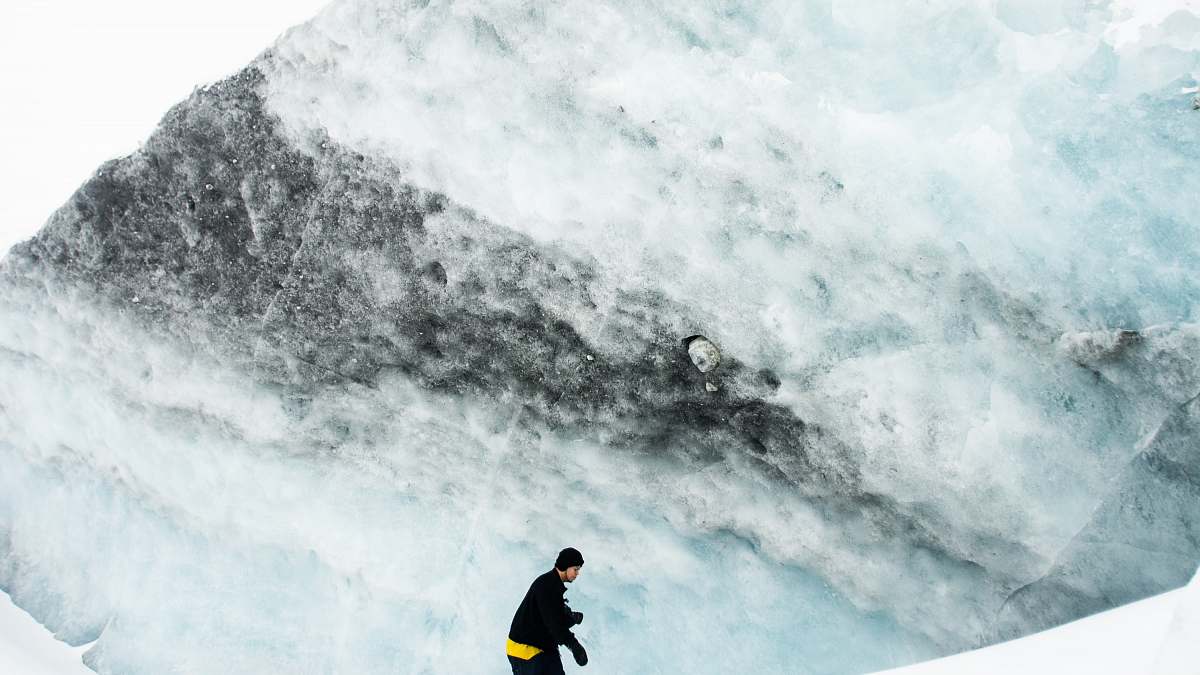canada man wearing black jacket and black beanie cap on icy mountain columbia icefields tour