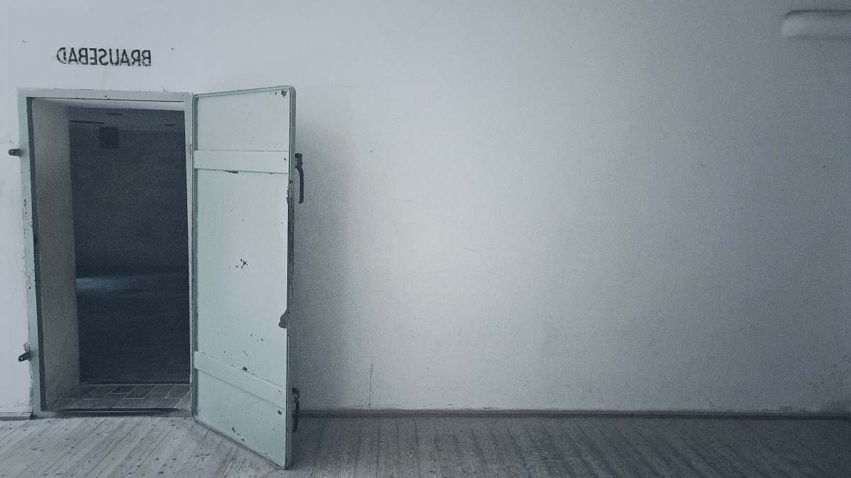 dachau open gray wooden door gas chamber