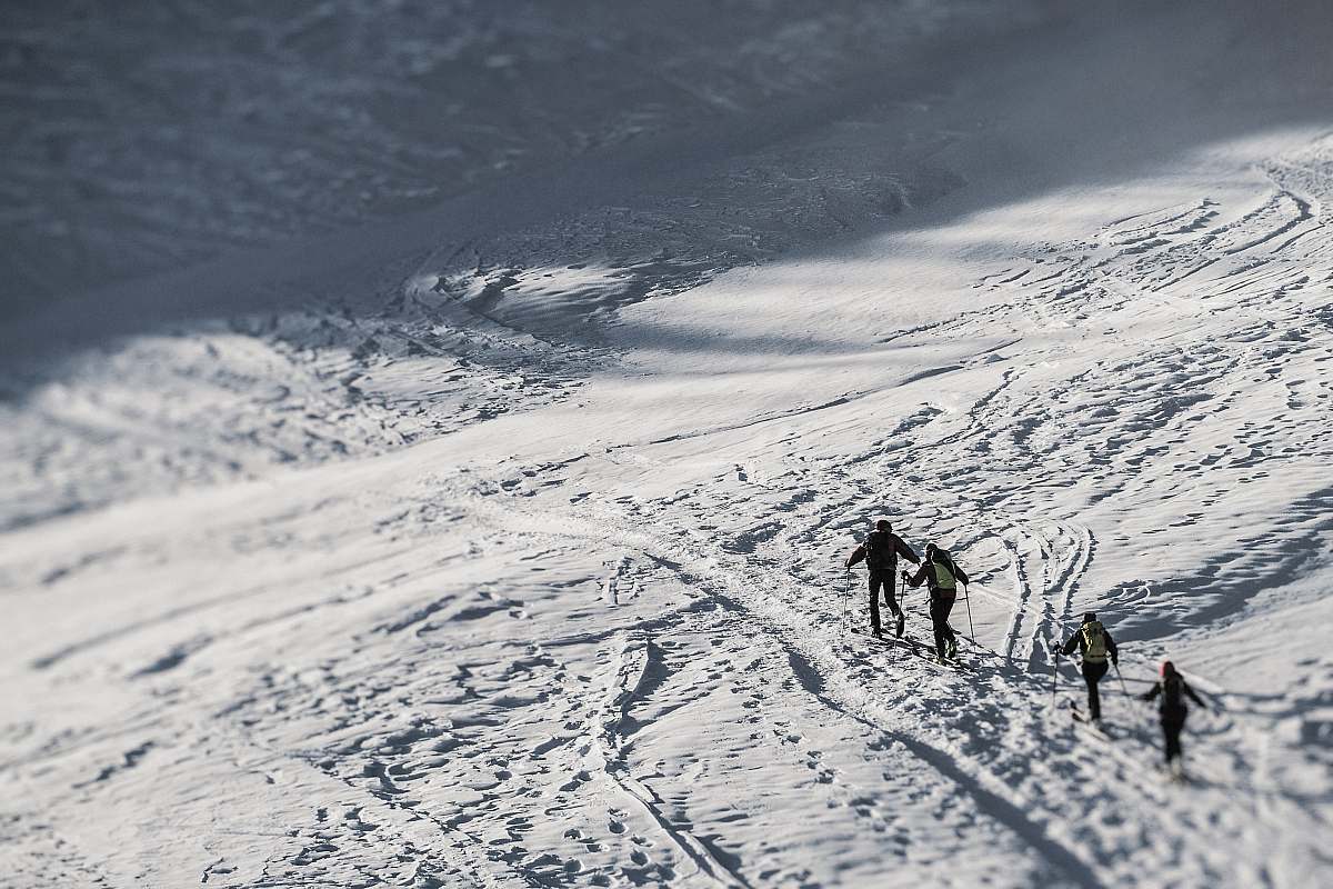 mountain people walking on snow covered ground during daytime san pellegrino pass