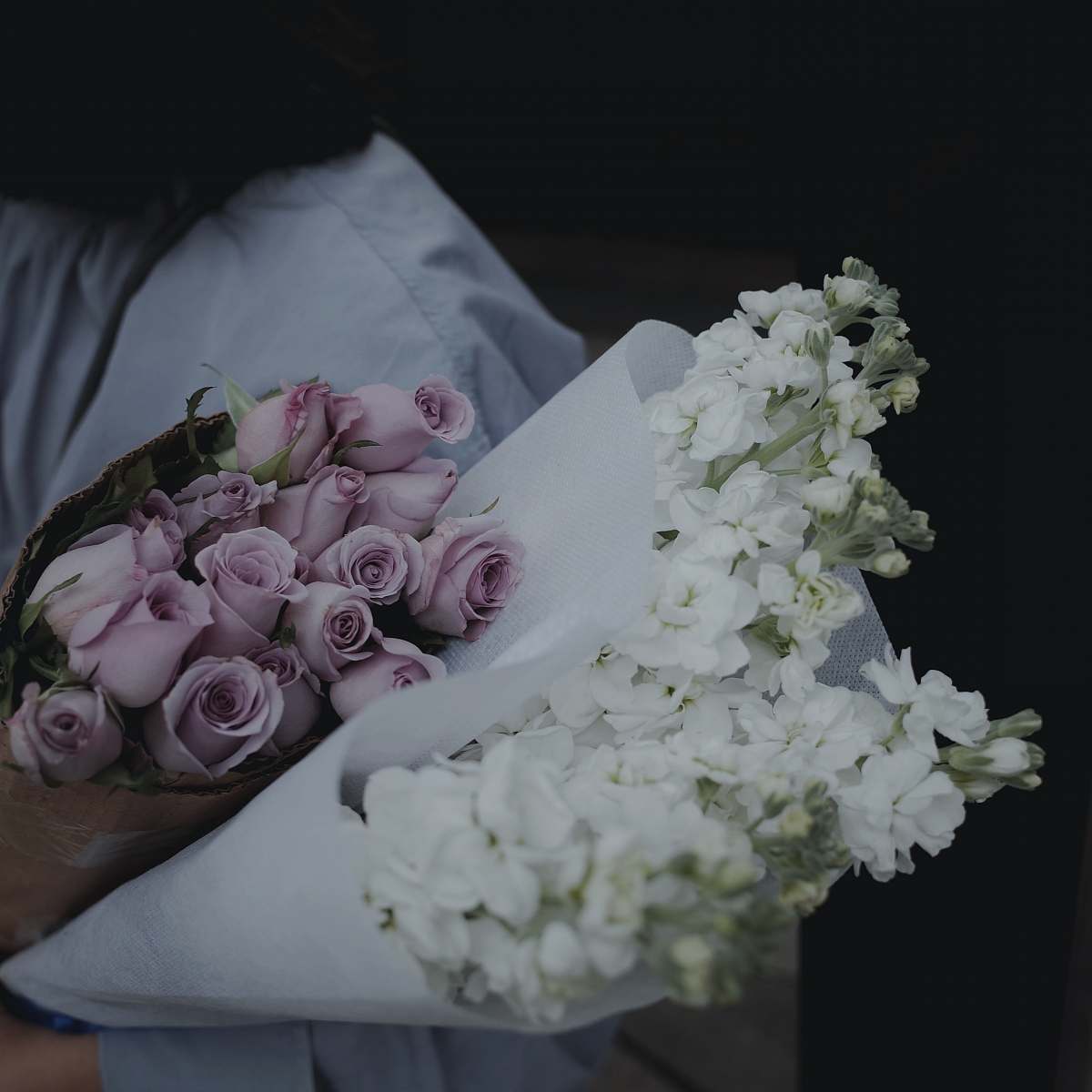 flower person holding purple and white flower bouquet art