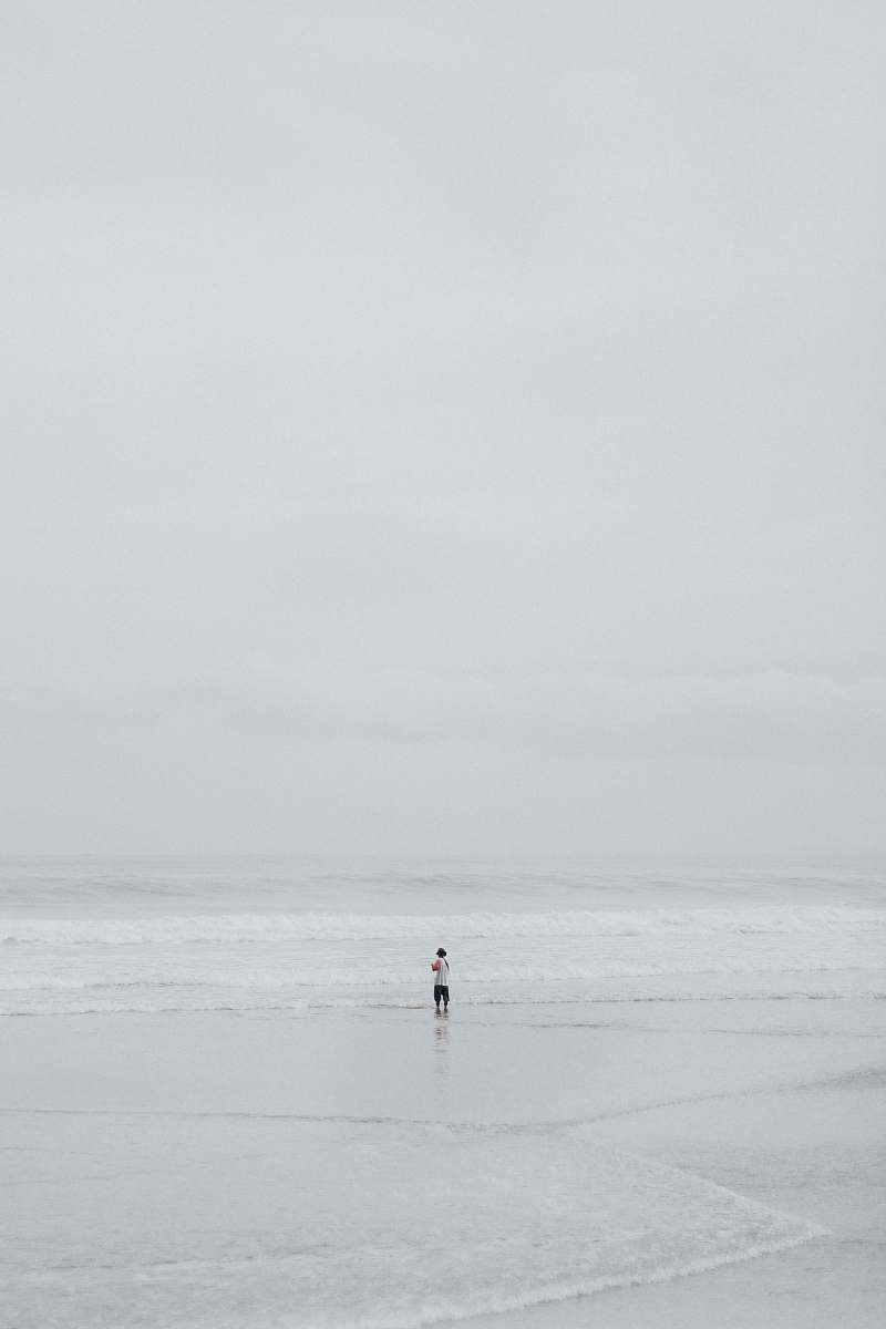 beach person in middle of seashore ocean