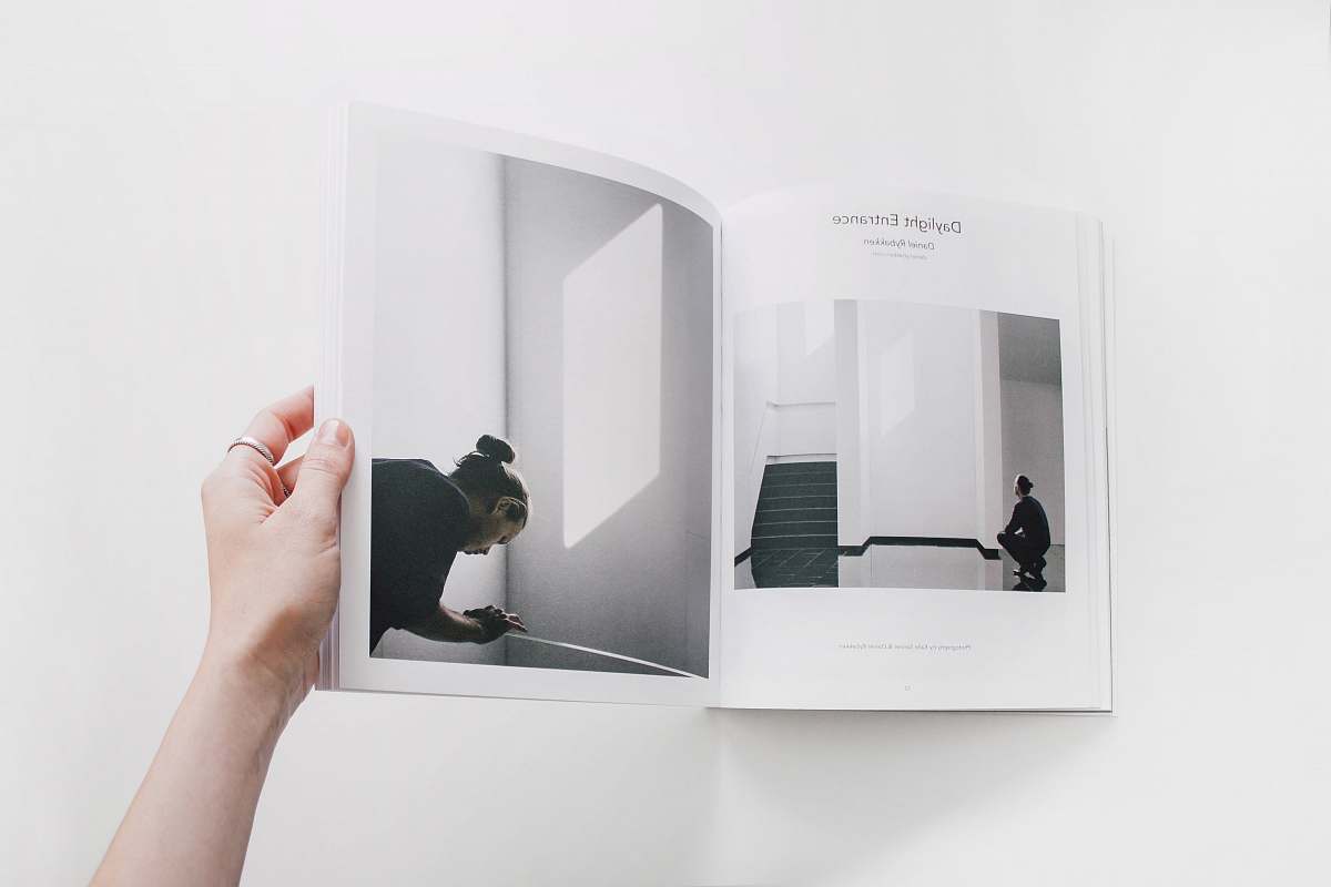 book person reading book on white surface magazine