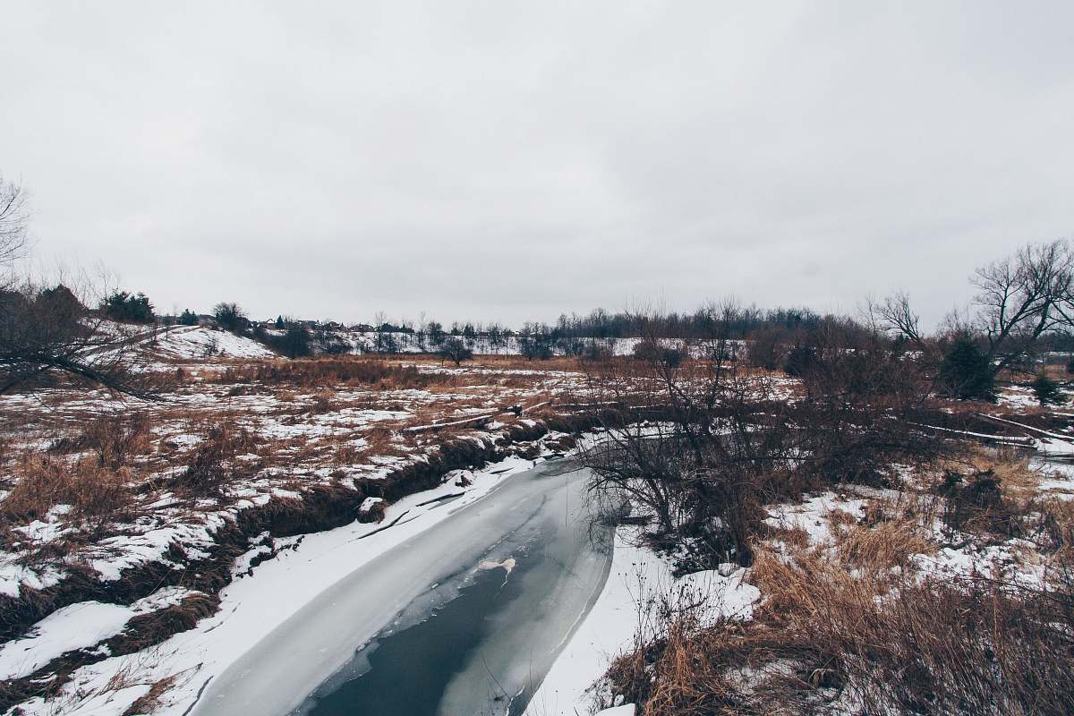 snow river covered snow under white sky water