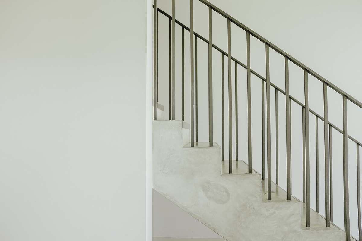 banister staircase with gray steel rail handrail