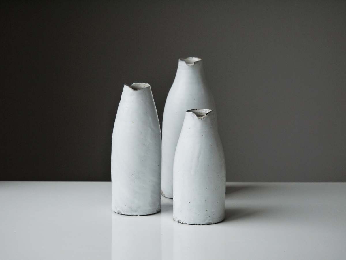 pottery three white vases on table white