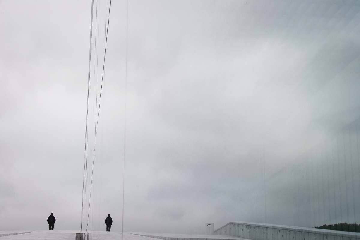 standing two person standing in the middle of road during daytime man