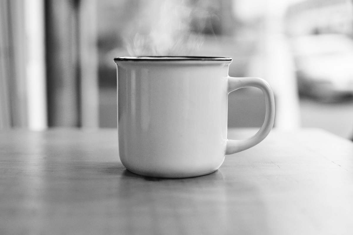 black-and-white white ceramic mug on table surface cup