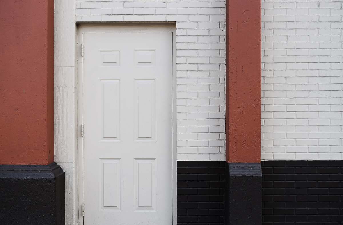 brick white wooden 6-panel door new york