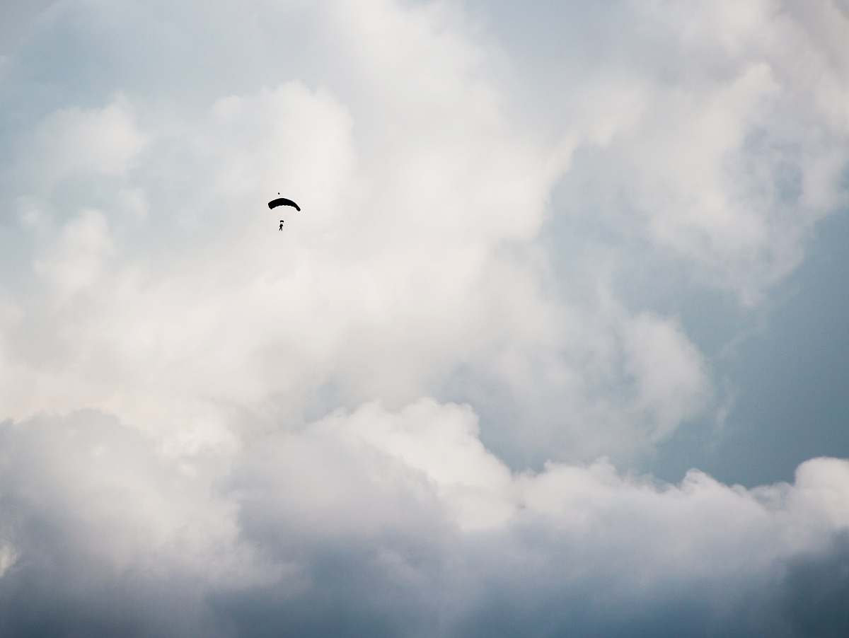 cloud worms eye view photography of person paragliding sky