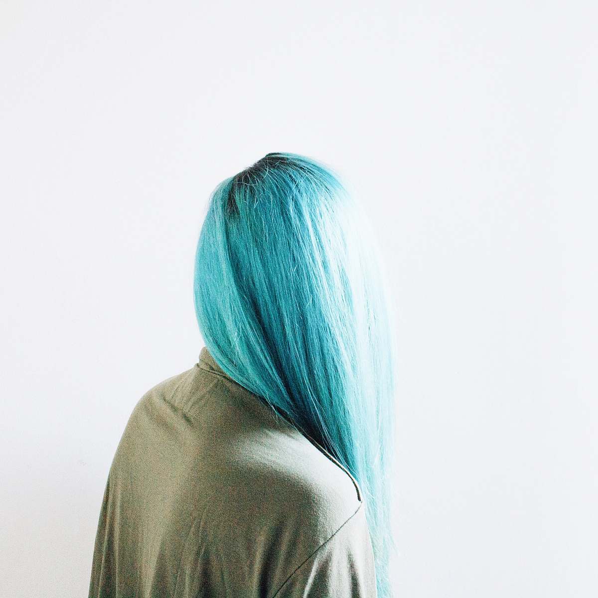 blue teal-haired woman wearing brown top woman