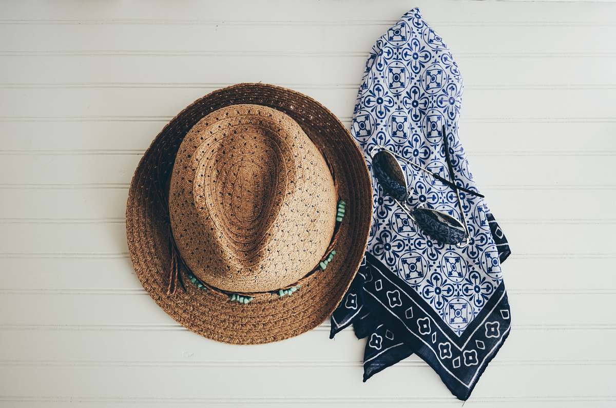sunglasses brown hat beside black handkerchief scarf