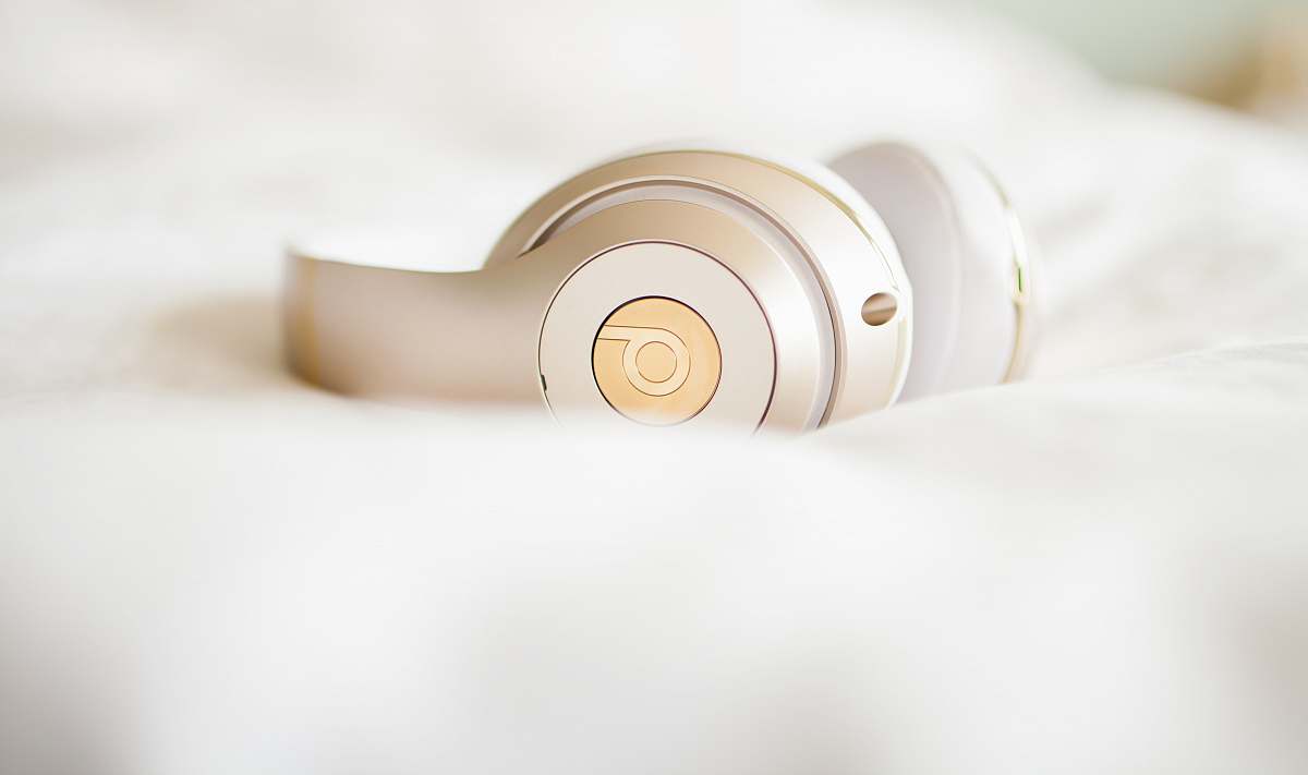 headphone gold edition Beats by Dr.Dre wireless headphones on top of white textile beats headphone