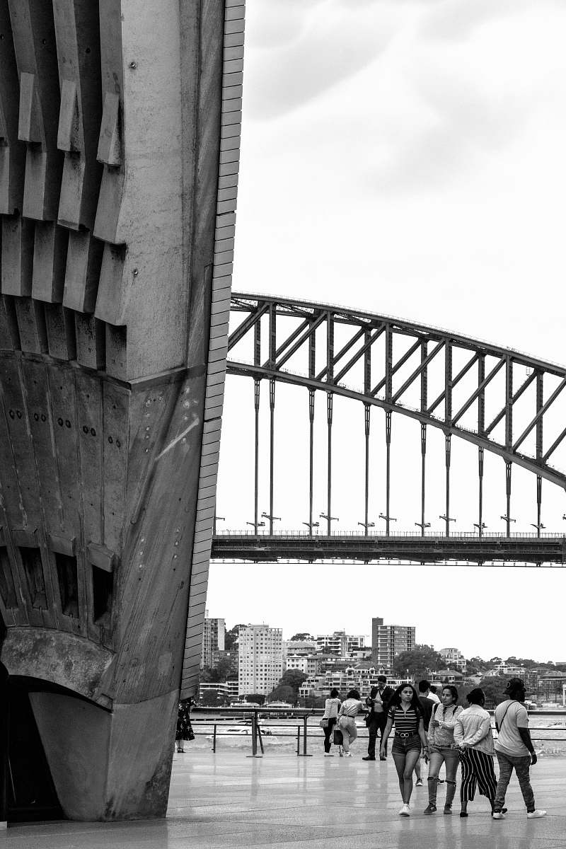 person grayscale photography of people walking near building black-and-white