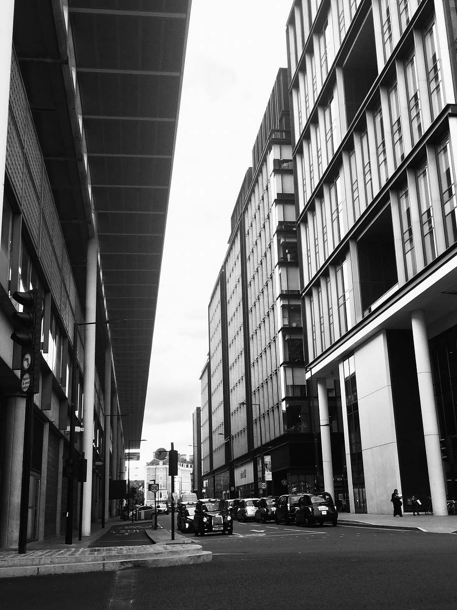 black-and-white grayscale photography of vehicle traveling on road during daytime path