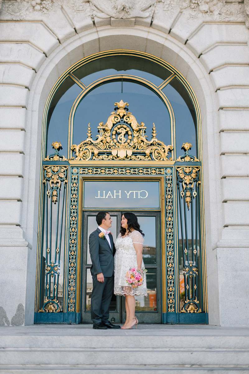 people man and woman standing in front of a city hall person