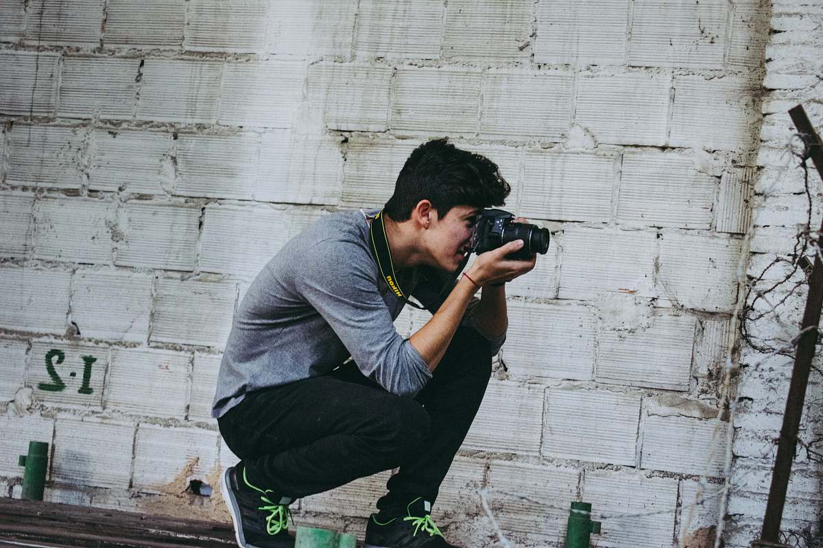 people man holding camera person