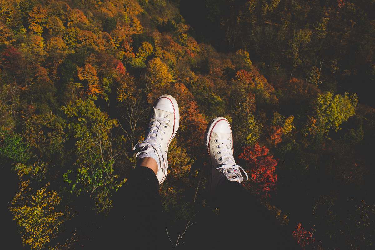 person pair of white low-top sneakers shoe