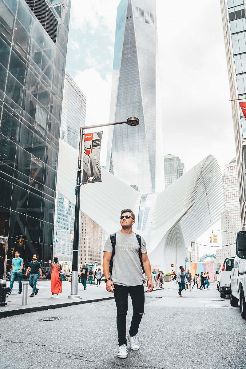 person people standing near city with high-rise buildings under white and blue sky during daytime pedestrian