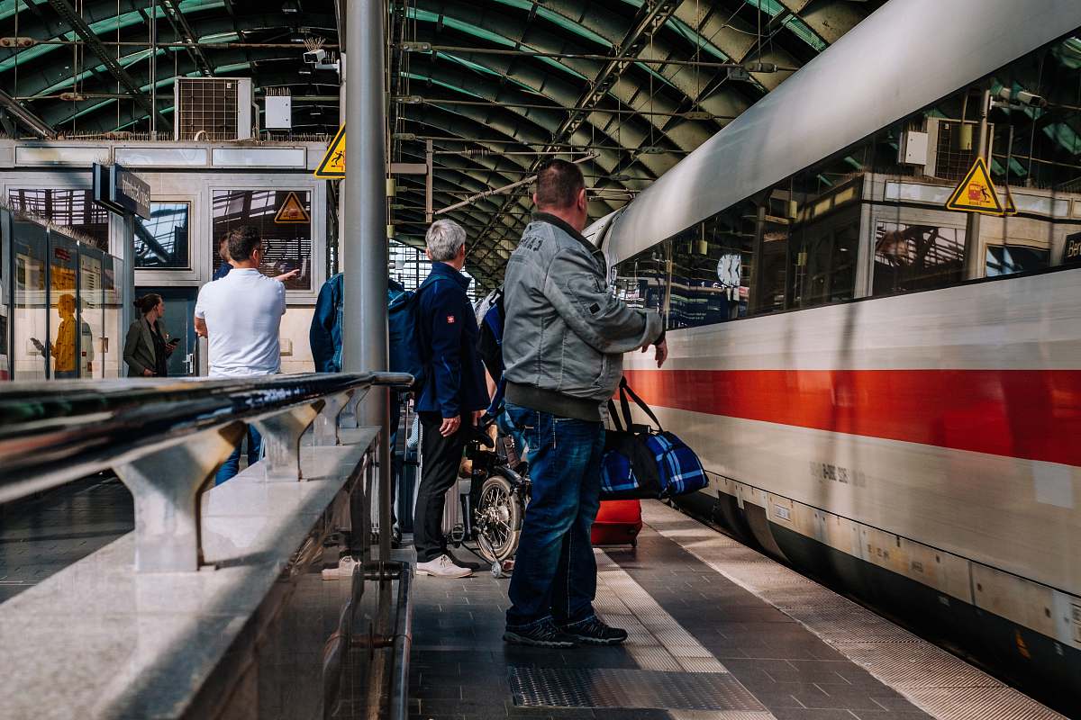 person people standing near train train
