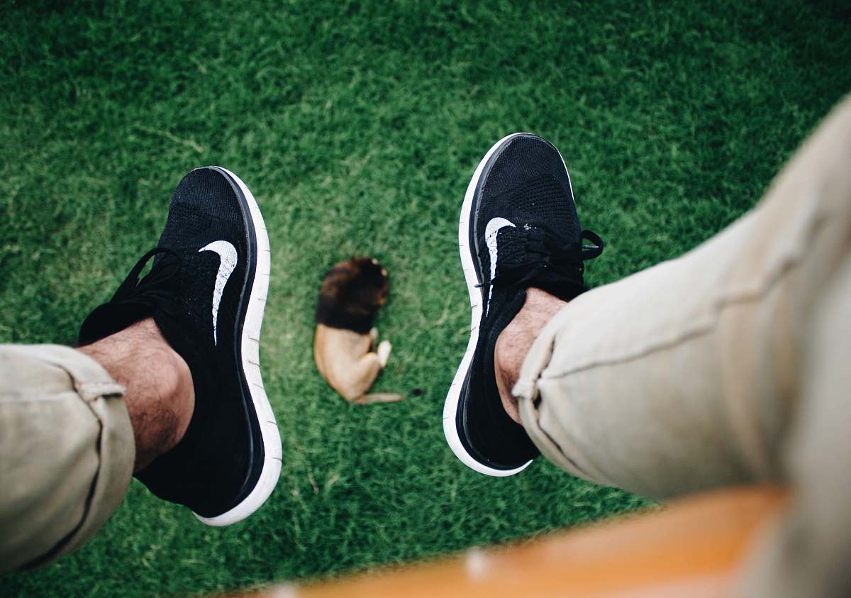 person person showing pair of Nike shoes people