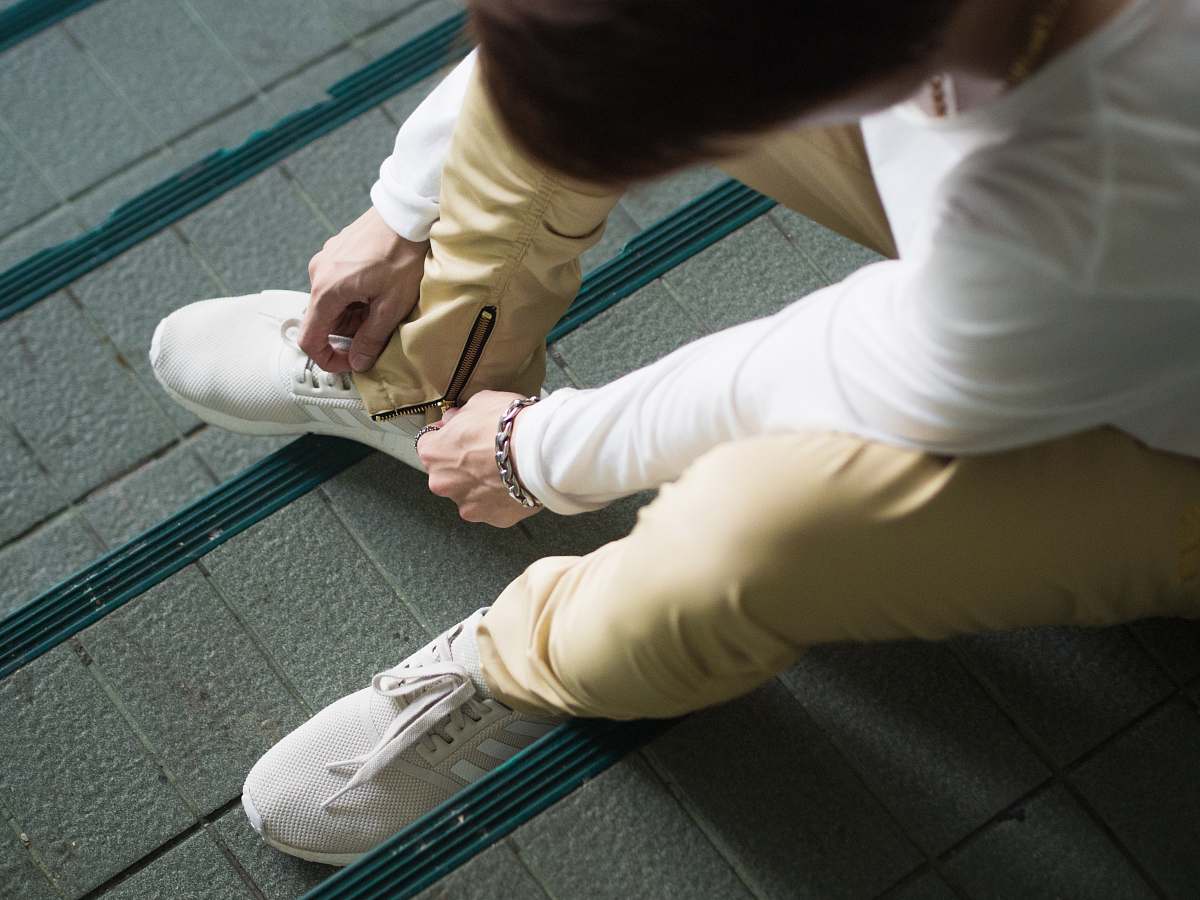 person person sitting and zipping his yellow pants people