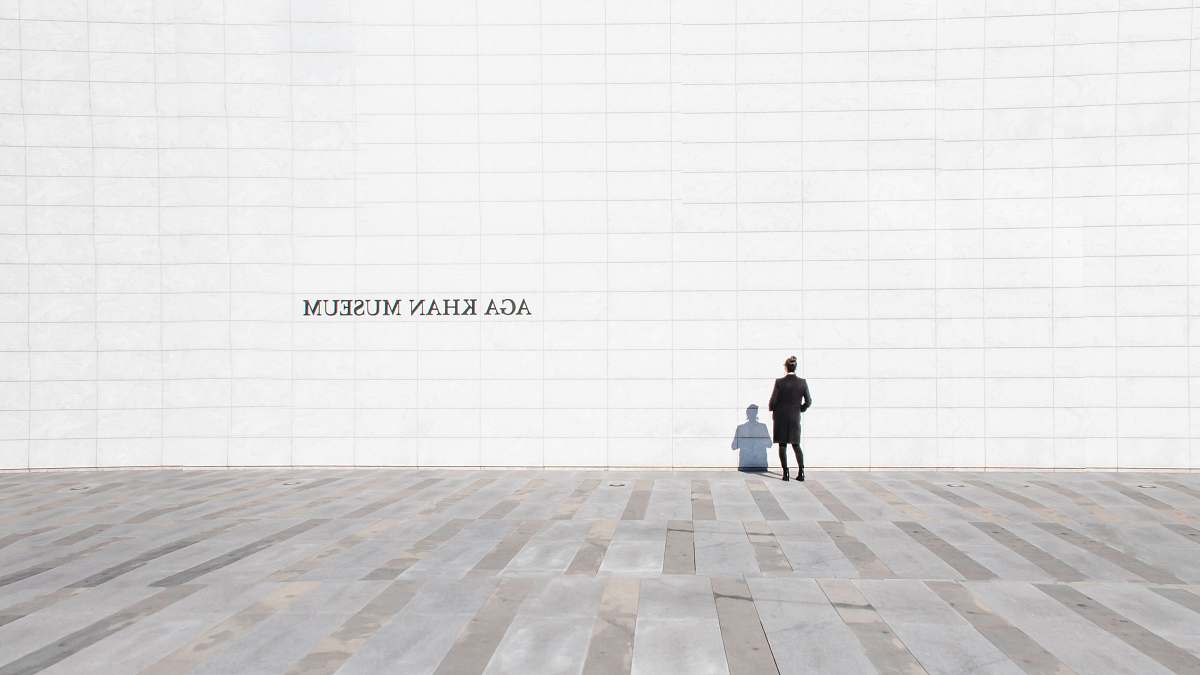 person person standing and facing white painted wall floor