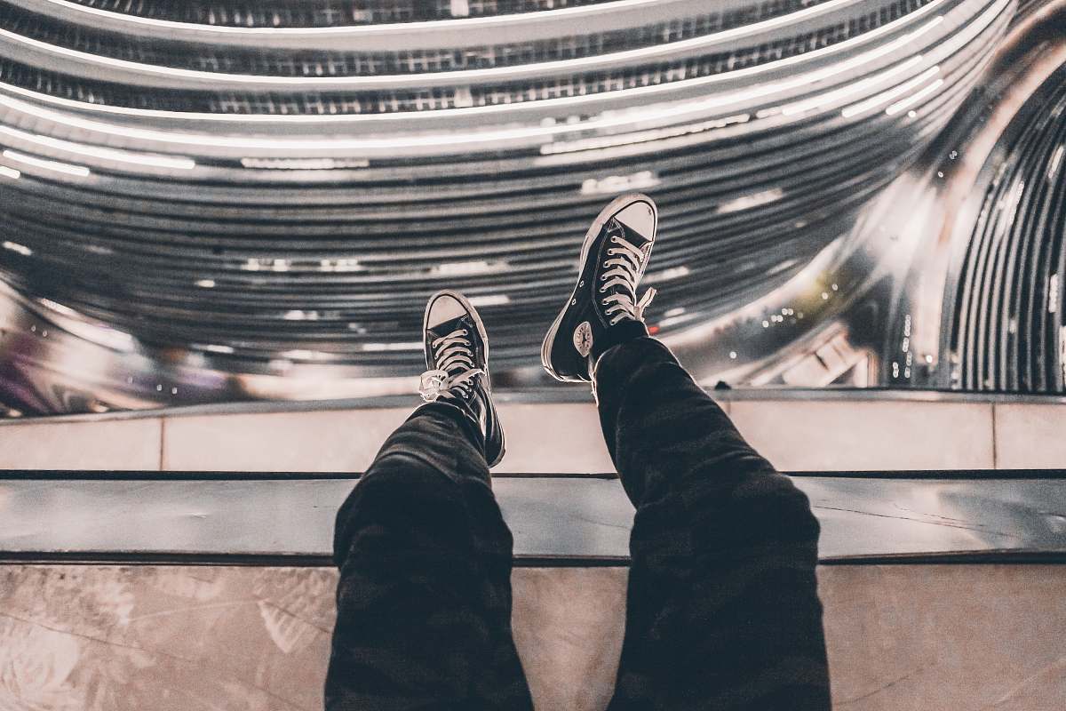 person person taking photo of black Converse sneakers people
