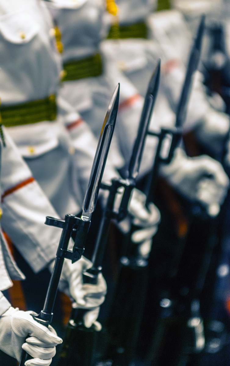 weapon selective focus photography of people holding spears weaponry