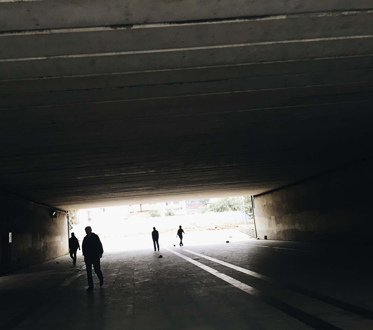 person silhouette of person standing on tunnel tunnel