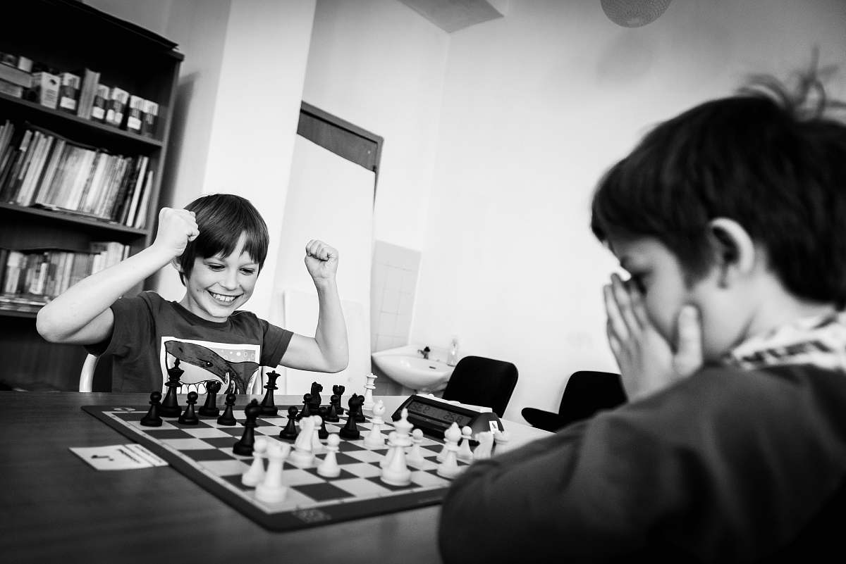 person two boy playing chess grayscale photo black-and-white