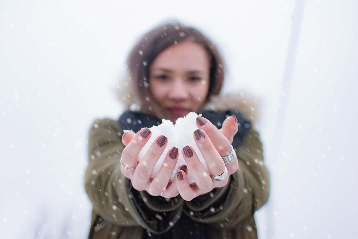 person woman holding snow at daytime people