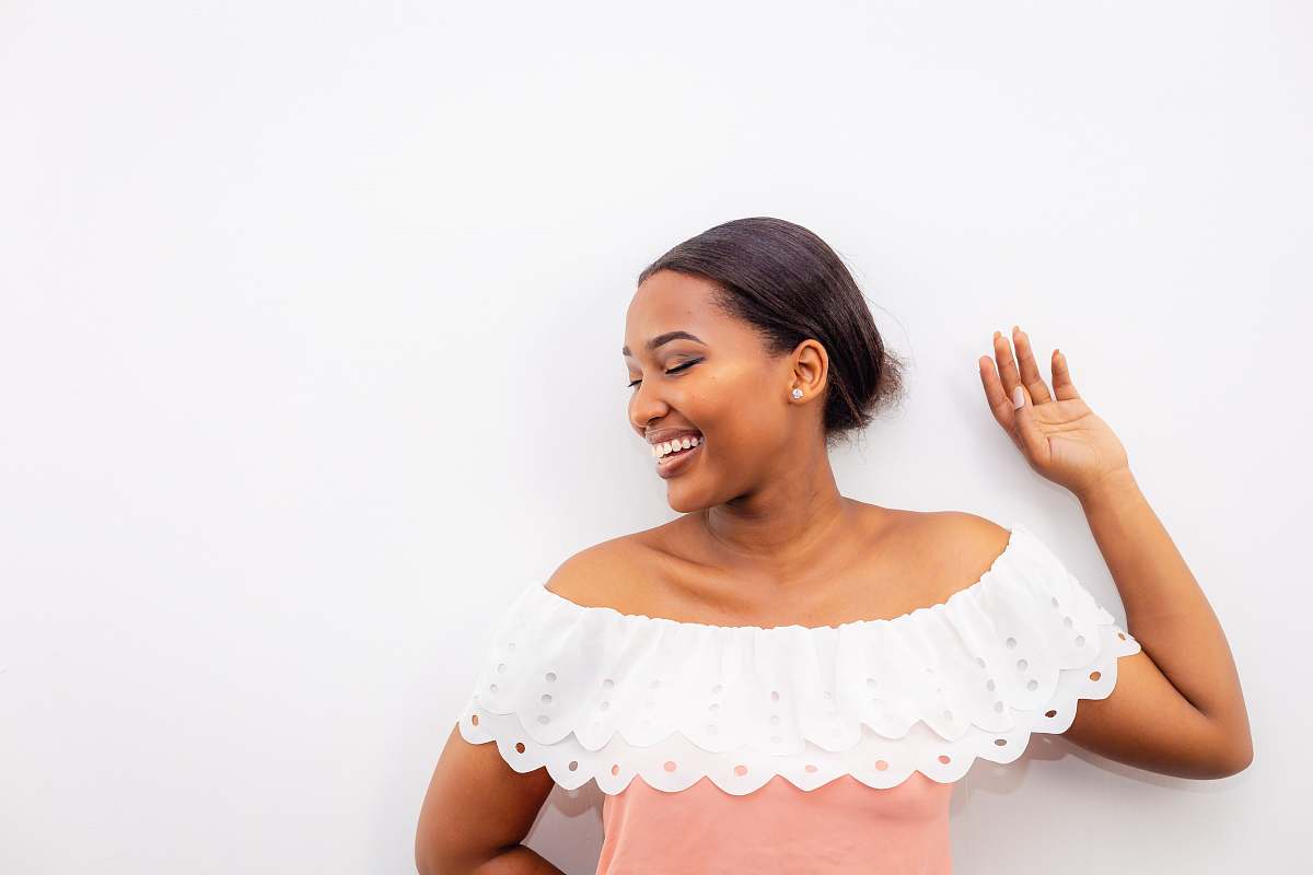 person woman in white bertha collar blouse leaning on white wall female