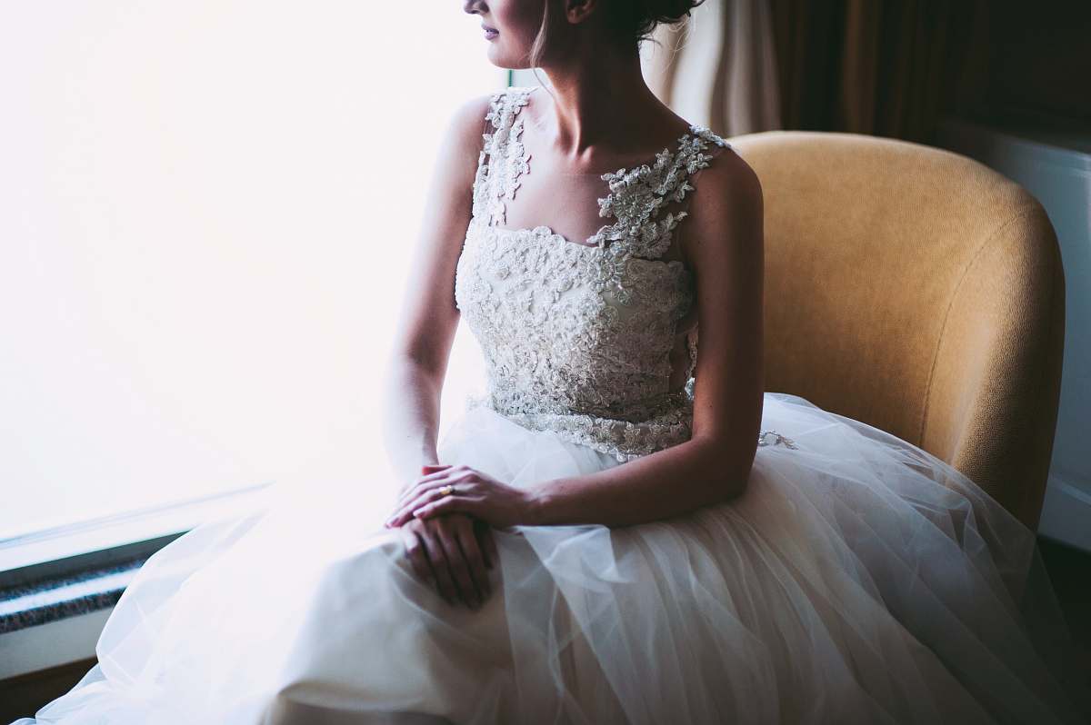 people woman in white wedding dress sitting near window person
