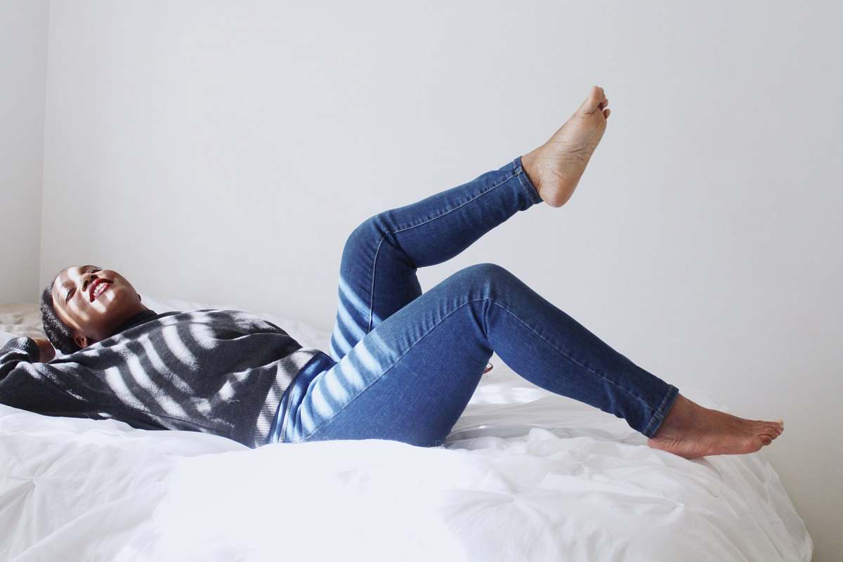 person woman laying on white bed people