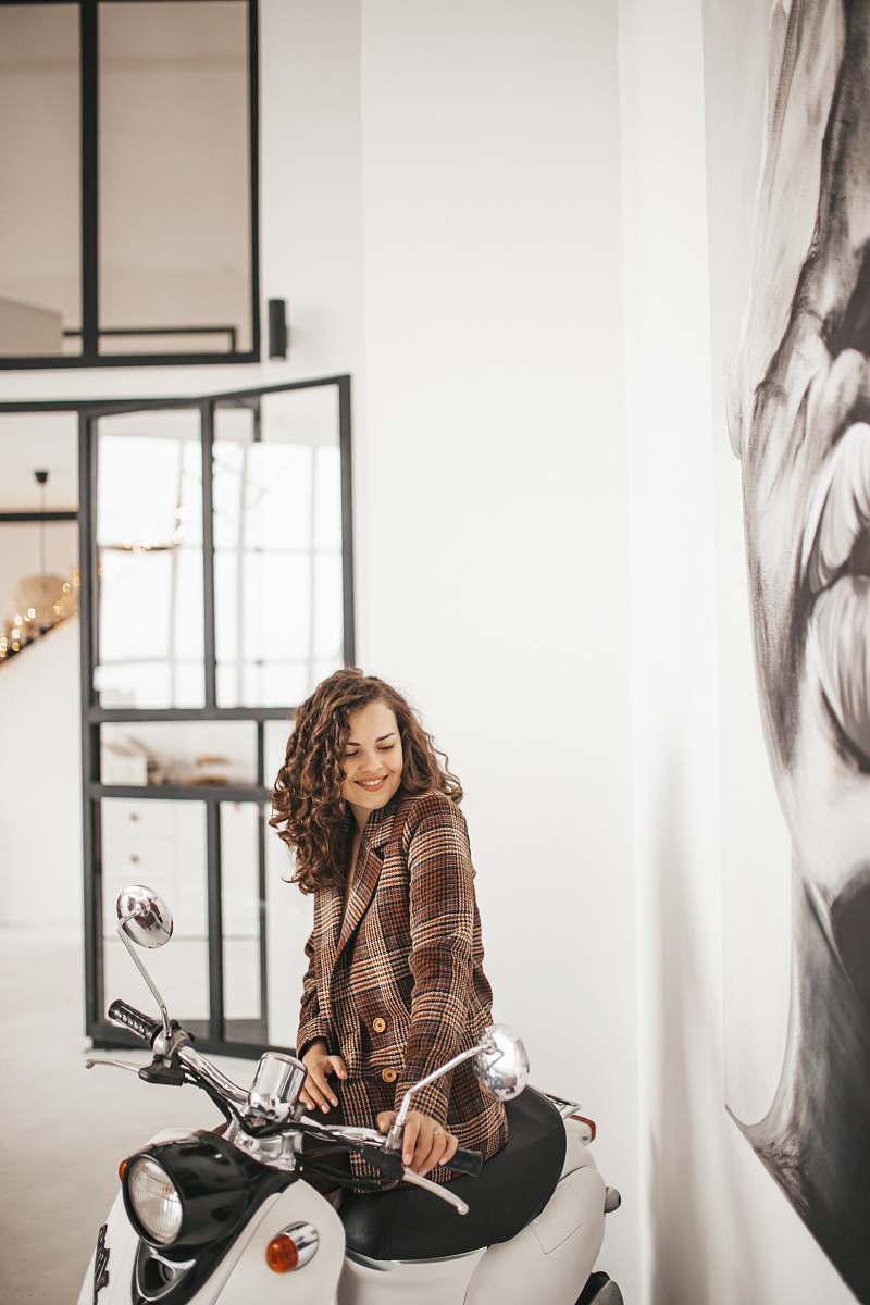 vehicle woman riding white motor scooter person