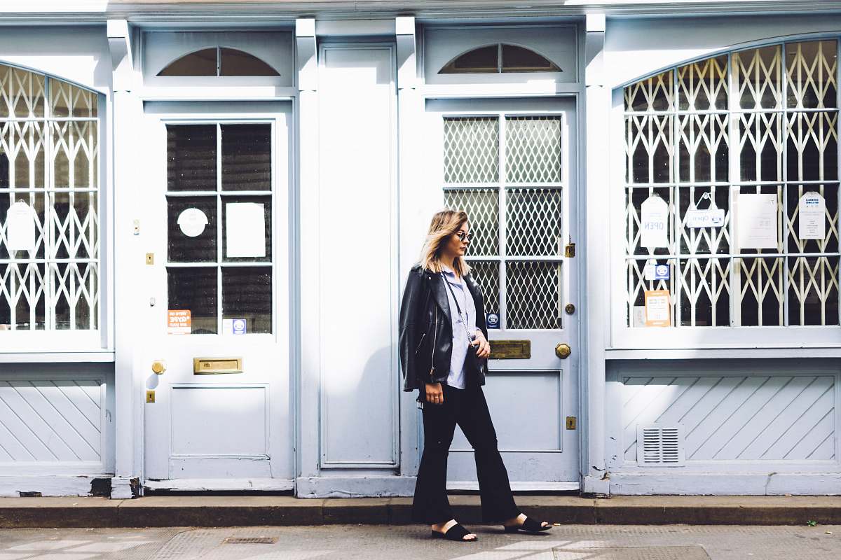 people woman standing beside the door person