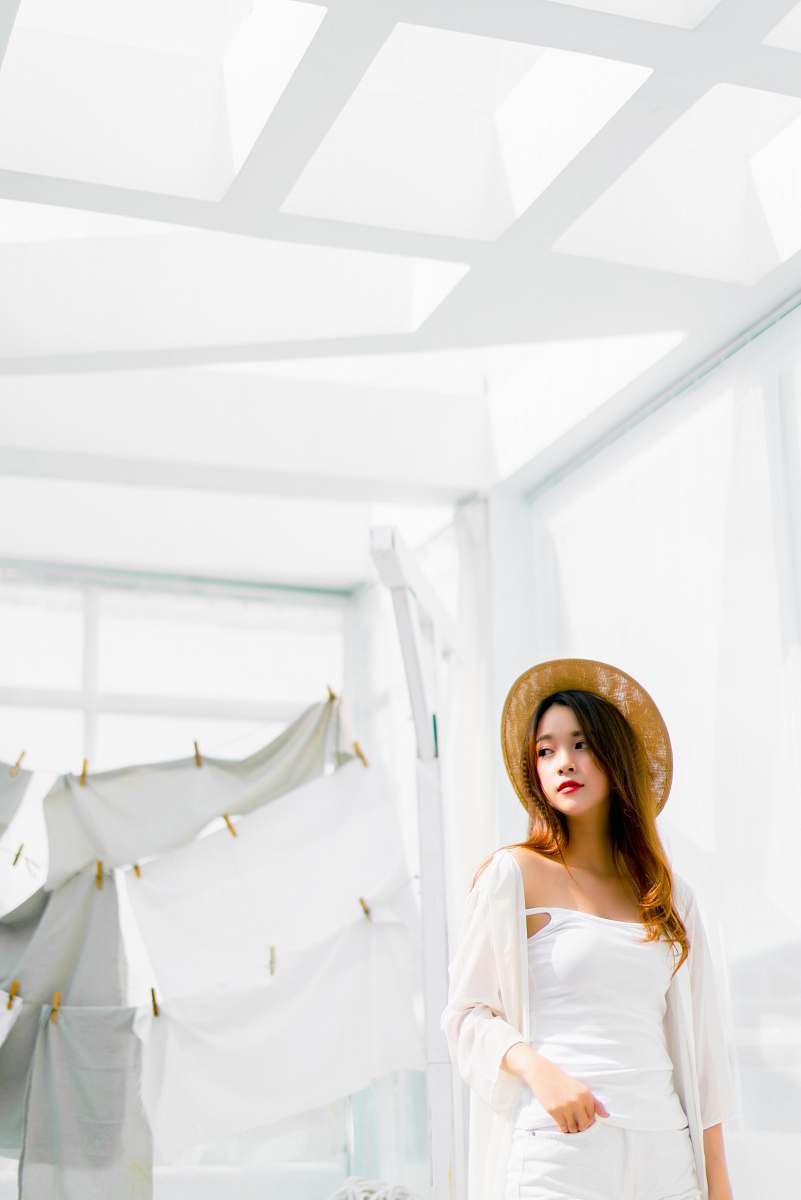 person woman standing near hanging clothes people