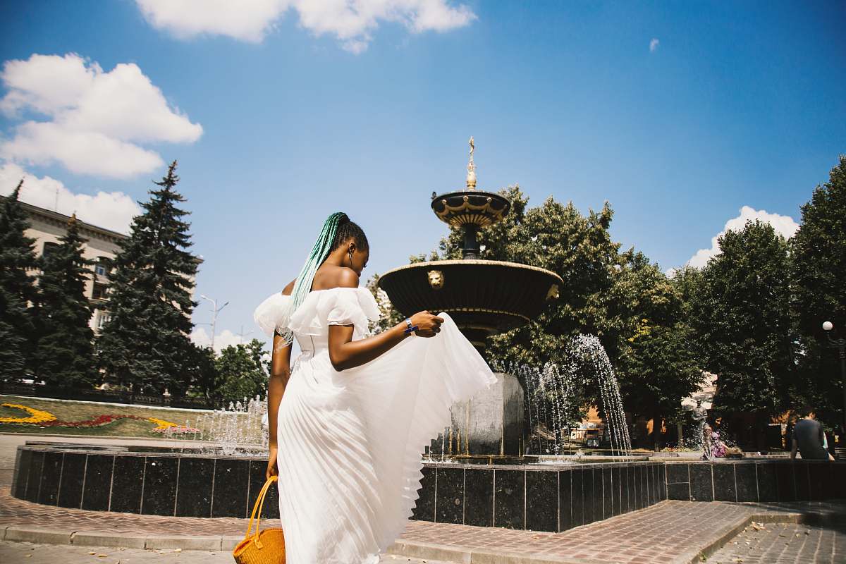 people woman standing near water fountain person
