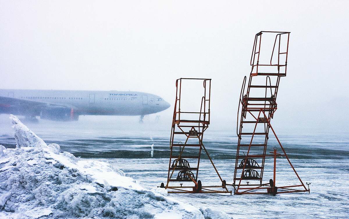 snow time lapse photography of airplane on runway chair