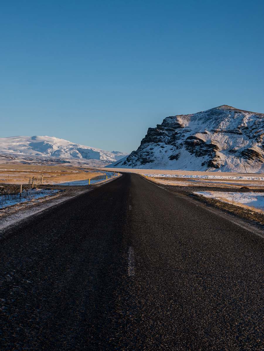 road empty concrete road with snow capped mountain background landscape
