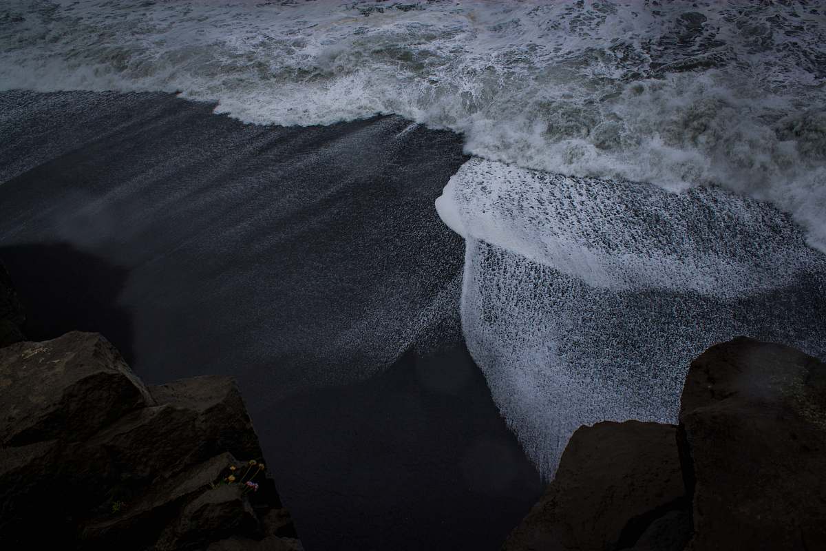 rock waves crashing on shore water