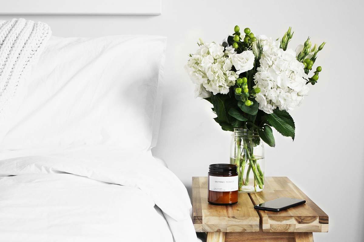 home flowers in clear glass vase on table plant
