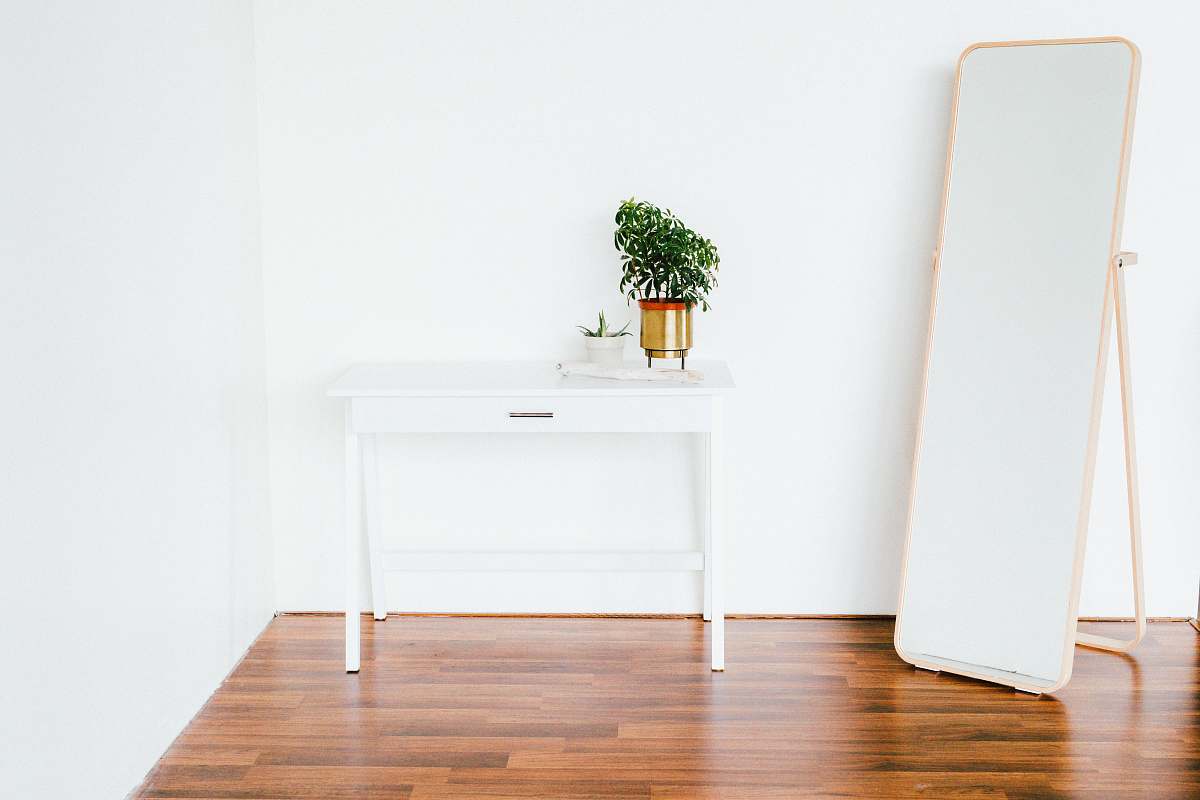 home white wooden side table beside white wall wood