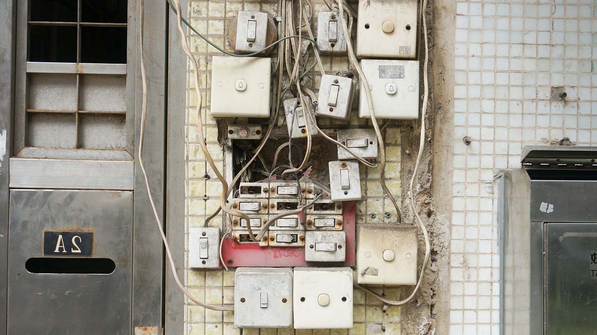 wiring several assorted power switches mounted on white wall switch