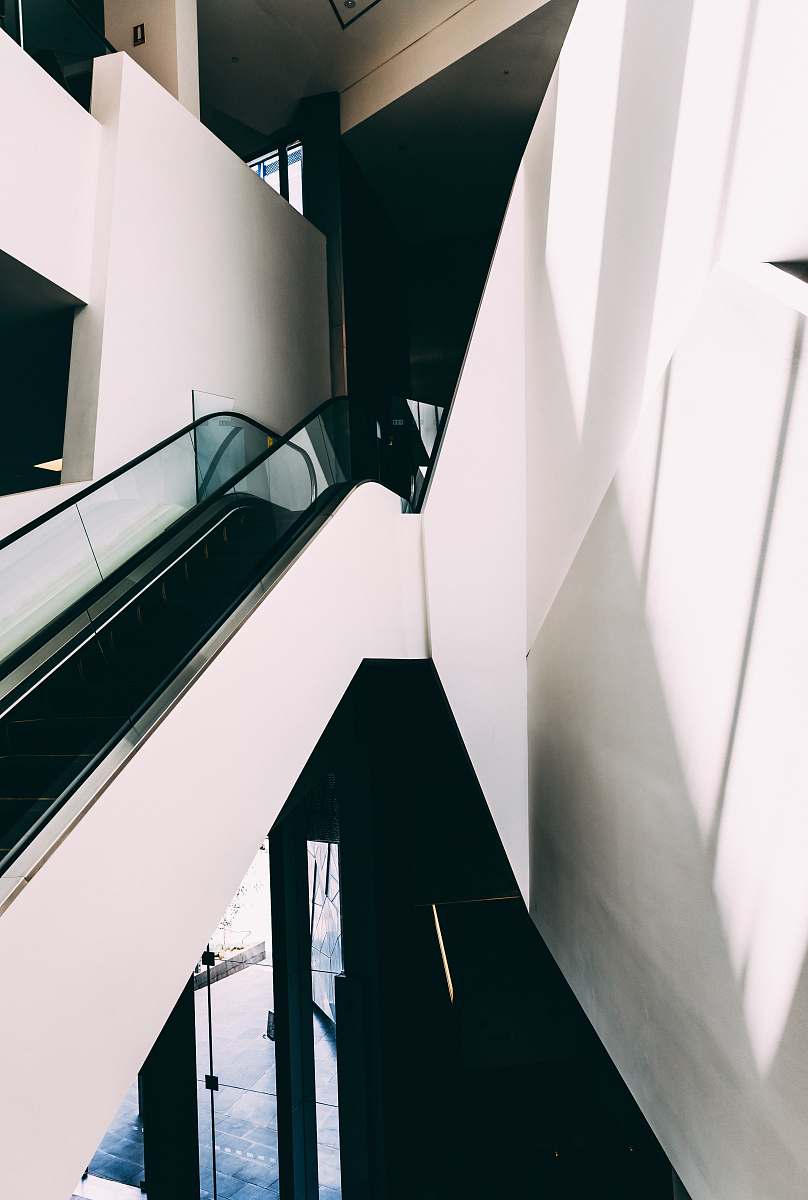 australia white and black escalator inside building indoors