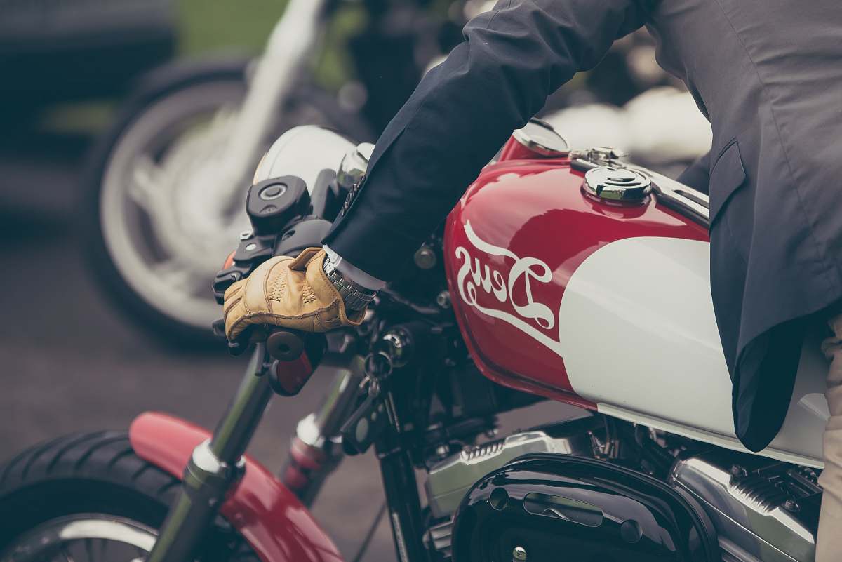 transportation person riding red and gray motorcycle australia