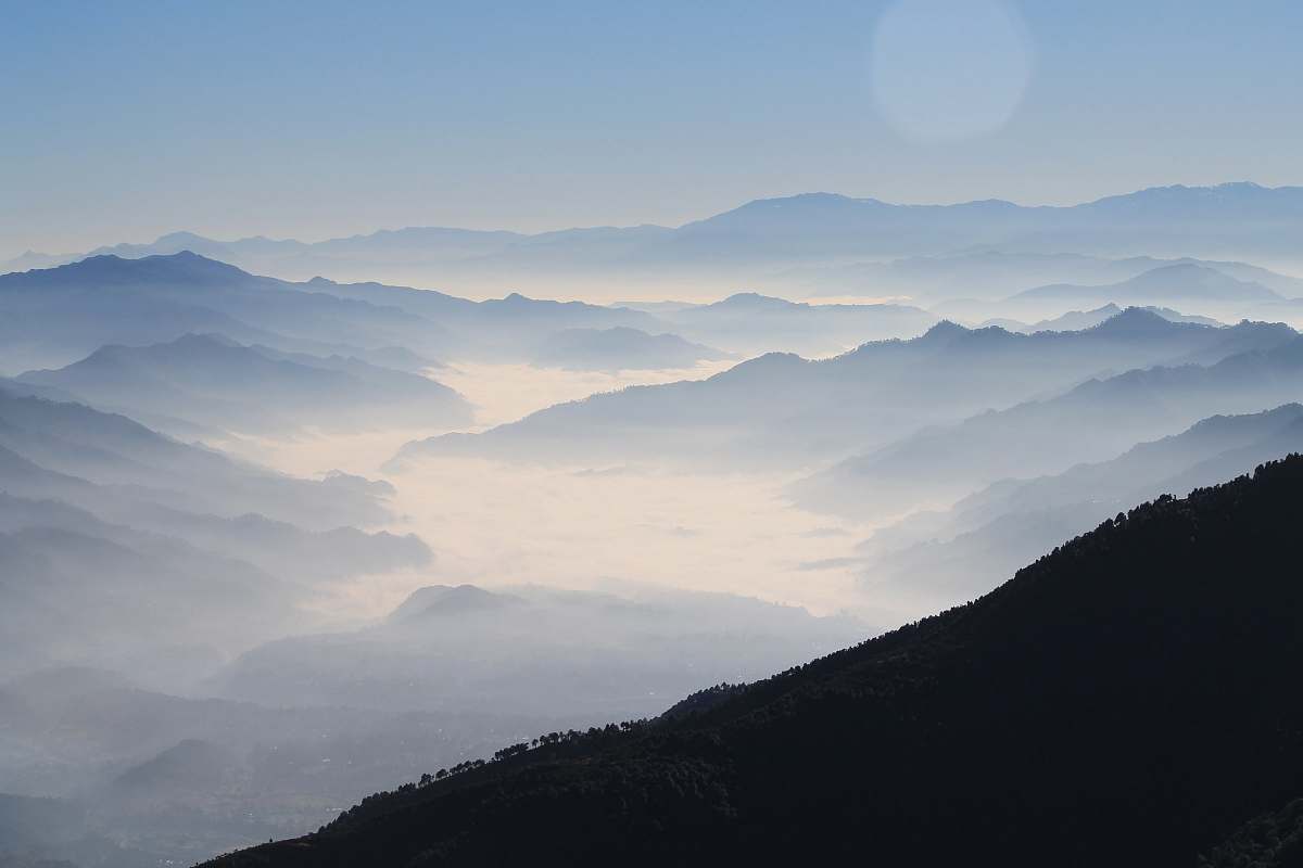 nature aerial photography of mountain range covered in clouds at daytime grey