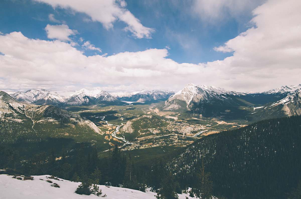 nature aerial photography of mountains under white cloudy skies outdoors